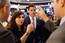 Stacey Cunningham in conversation with three men at the New York Stock Exchange 