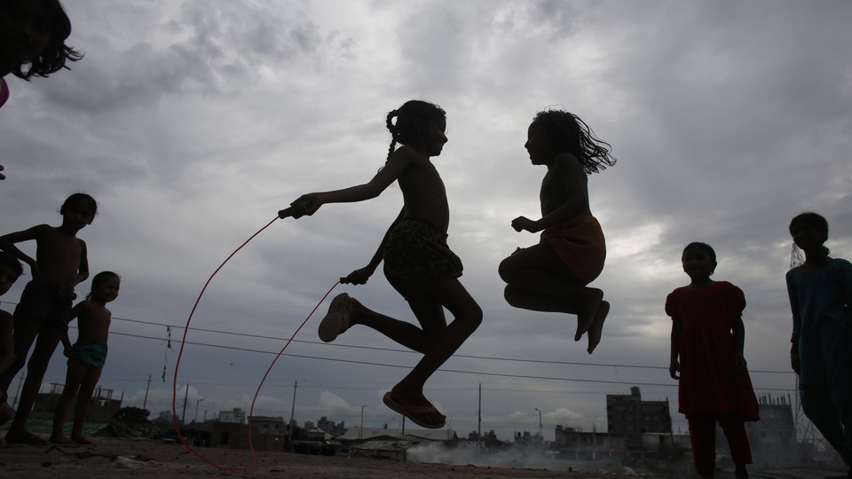 Two children play jumprope. 
