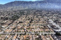 An aerial view of empty lots in a residential neighborhood, after being cleared of wildfire debris