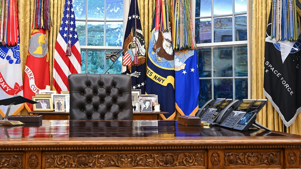 An empty chair at the Resolute desk in the Oval Office