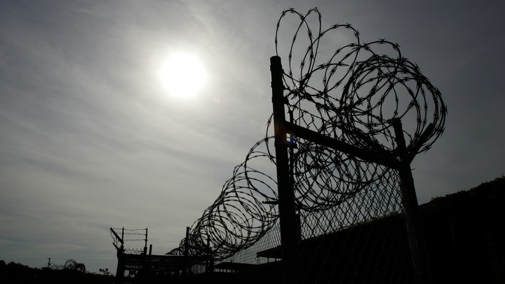 A rusting fence with barbed wire