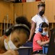 Tonette McQueen helps Zion Graham, 8, with a summer school assignment at Hunter Elementary in Greensboro, North Carolina., July 19, 2021.