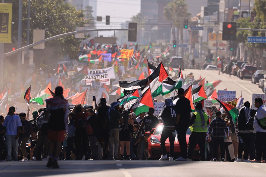 Pro-Palestine marchers walk in a street in Los Angeles.