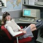 An Apple employee poses with a personal computer in 1986.