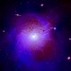 A composite image of the Perseus galaxy cluster, rendered here in bright purple, located 250 million light-years from Earth