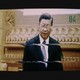 Chinese President Xi Jinping on a blurry television screen.