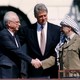 Rabin and Arafat shake hands, with Clinton behind them, on the South Lawn of the White House.