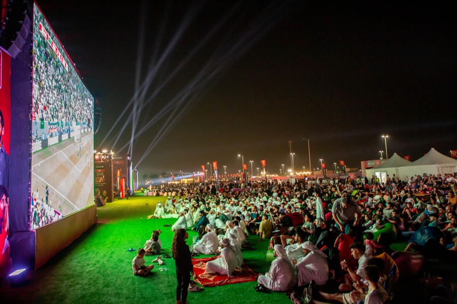 People gather to watch the World Cup on a giant outdoor screen.