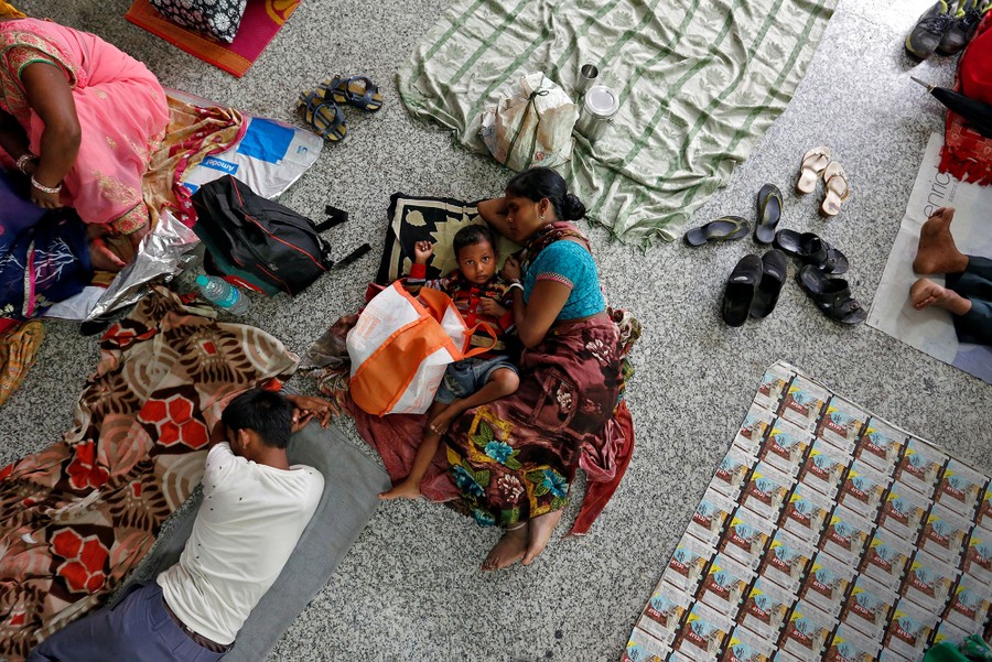 People rest on the floor outside the intensive care unit