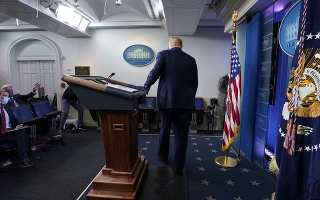 The president leaves the White House briefing room.