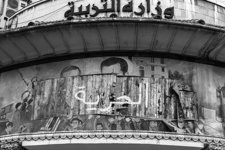 Picture of a defaced mural on a school in Damascus that once glorified Hafez and Bashar al-Assad. January 22, 2025.
