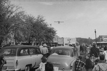 The 1953 turkey drop starts as the first bird is tossed from a low-flying plane.