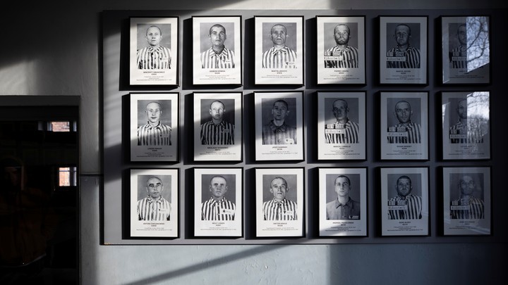A wall of pictures of former Auschwitz prisoners
