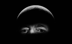A photograph of Jeff Bezos that has been edited to portray the billionaire's head as the surface of the moon