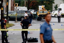 Law enforcement officers mark evidence near the site where Ahmad Khan Rahami, sought in connection with a bombing in New York, was taken into custody in Linden, New Jersey, 