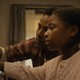 Two children touch a piano in “The Piano Lesson”