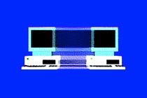 A pixelated animation of an early desktop computer splitting into two copies of itself