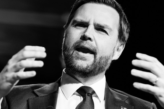 A black and white photo of JD Vance holding his hands out in front of him a foot or so apart