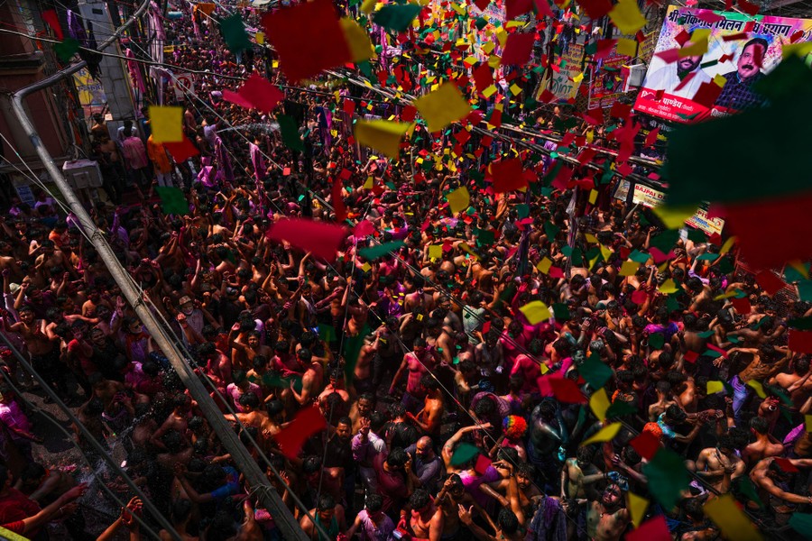An elevated view of a large crowd celebrating in a city street.