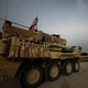 U.S. military vehicles drive in the town of Darbasiya next to the Turkish border, Syria, on April 28, 2017.