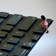 A child climbs onto a giant mockup laptop keyboard