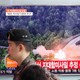 A South Korean soldier walks past a TV broadcast of a news report on North Korea firing what appeared to be several land-to-ship missiles off its east coast, at a railway station in Seoul, South Korea, on June 8, 2017.