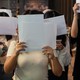 Protesters in China holding up blank pieces of paper