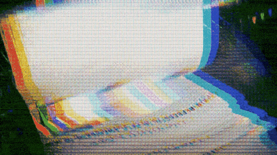 Highly pixelated gif of newspapers running through printing press
