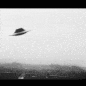 A short animation of a UFO, in the shape of a flying saucer, skipping around the sky