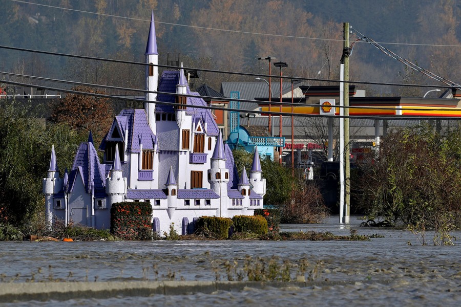 A replica of a fantasy castle stands in a flooded plain.
