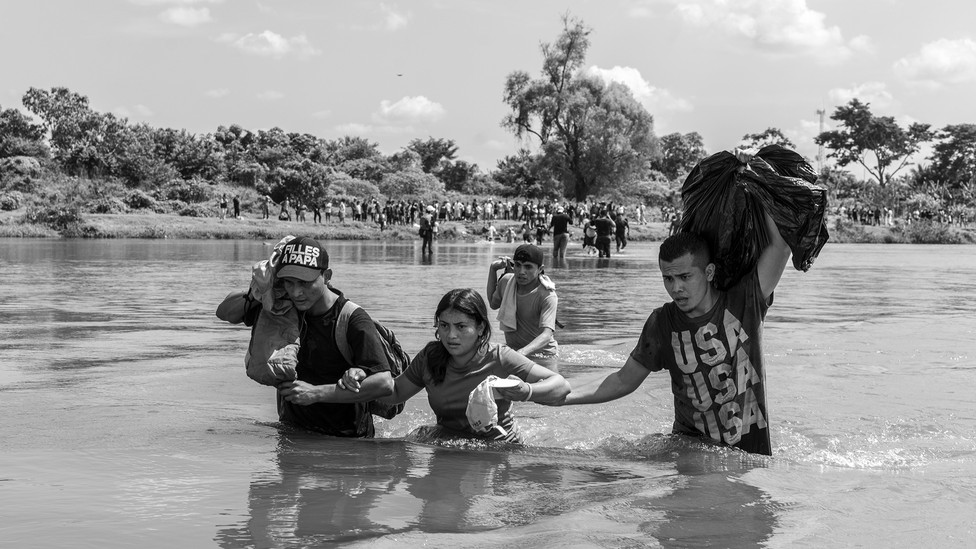 image of people wading through water