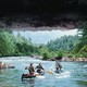 four men canoeing down a river