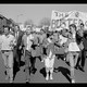 A black-and white still from the documentary "Deaf President Now!" showing Gallaudet University student protesters assembled outside.