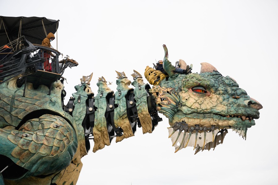 A large mechanized dragon carries passengers