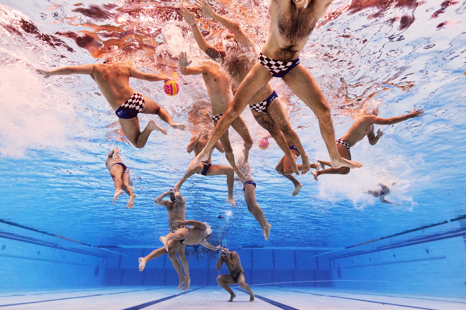 An underwater view of a water polo team