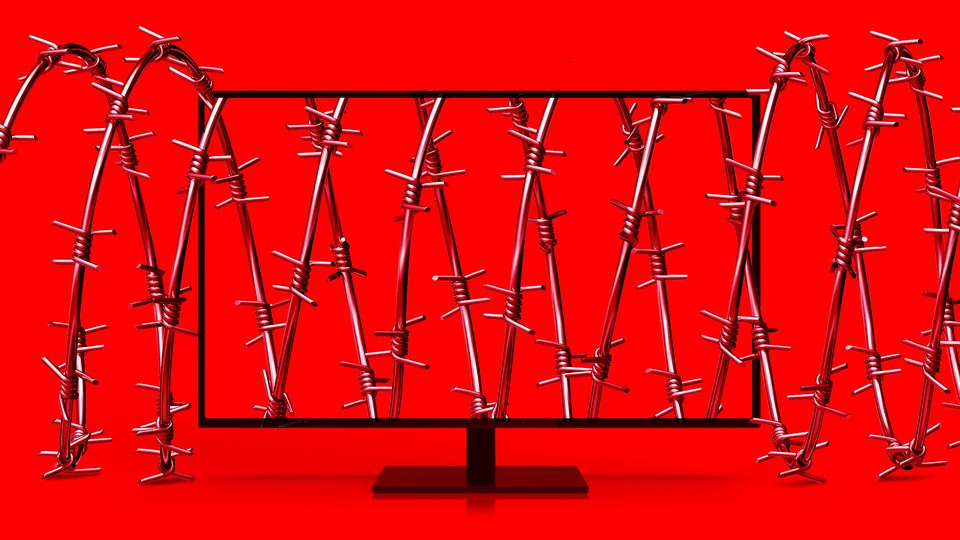 A computer screen tangled in barbed wire against a red background