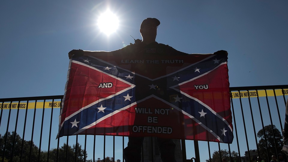 A man holding a Confederate flag