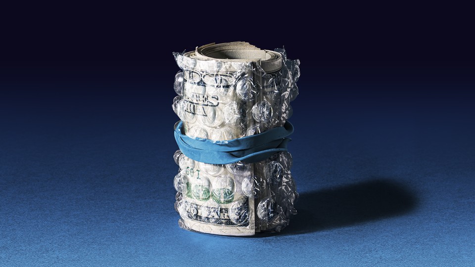 a stack of 100 dollar bills rolled in bubble wrap