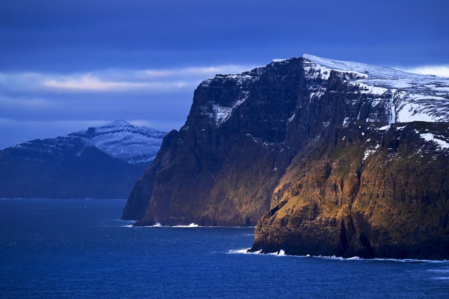 Mountain cliffs meeting the ocean