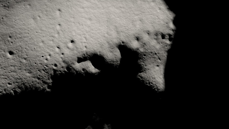 An image of the moon's south pole, slate-colored and covered in shadows