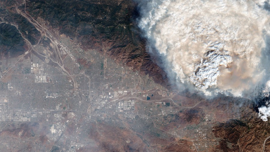 A satellite image of a large plume of smoke rising beside the city of San Bernardino