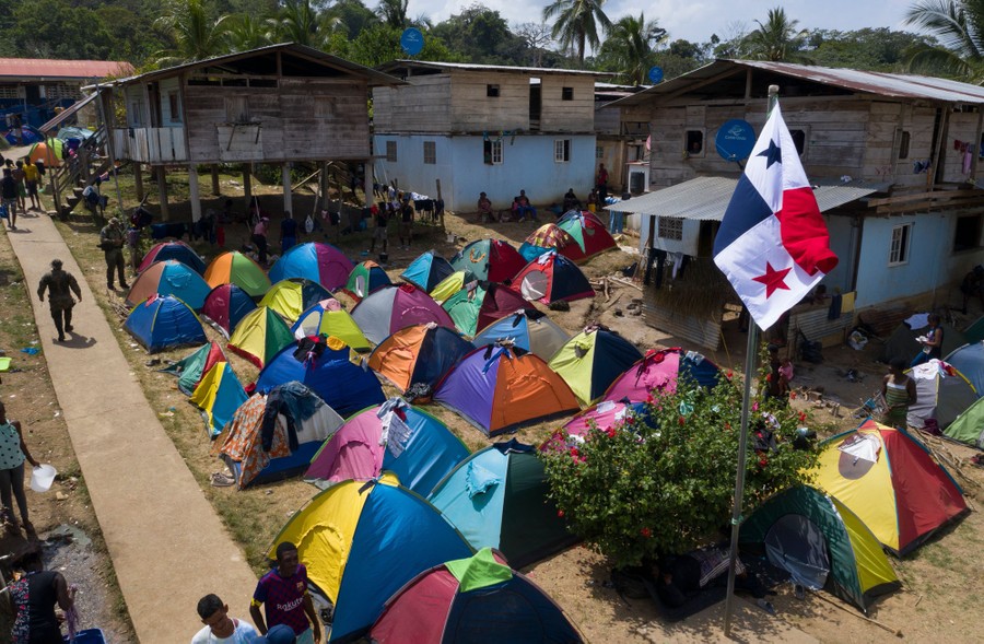 A view of a couple dozen tents set up in a migrant camp