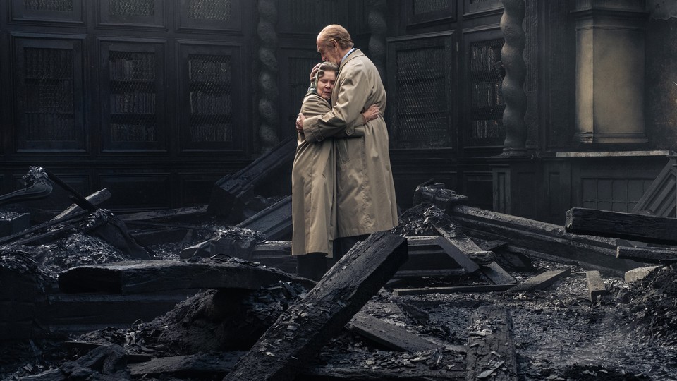 Imelda Staunton and Jonathan Pryce embracing while standing atop a pile of rubble in "The Crown"
