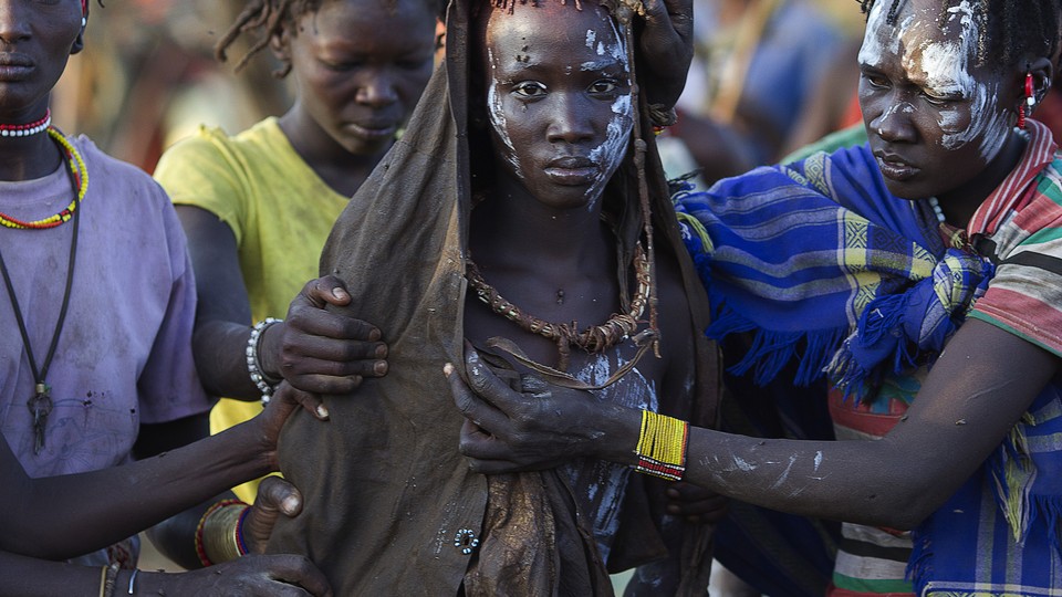 A Pokot girl walks to a place where she will rest after being circumcised in a village in Baringo County, Kenya. (Siegfried Modola/Reuters)