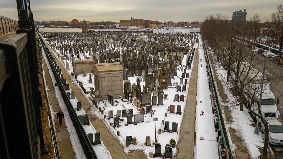 A photo of a snow-covered cemetery in New York City