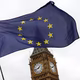 A European Union flag is waved in front of Big Ben outside the Parliament in London on March 28, 2017. 
