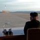 Kim Jong Un watches the launch of a Hwasong-12 missile.