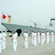 Members of the Chinese navy stand on the deck of a naval destroyer.