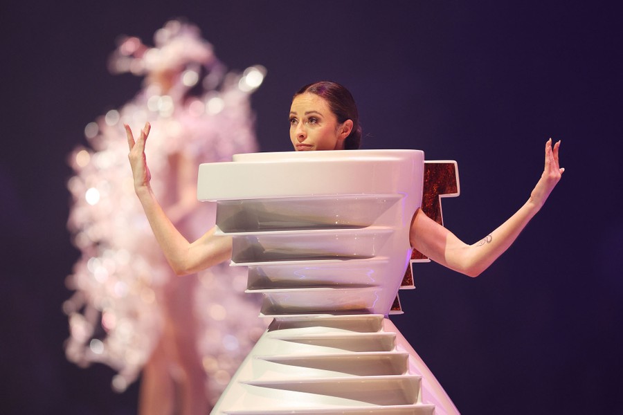 A model wears a garment that looks a bit like porcelain shelving.
