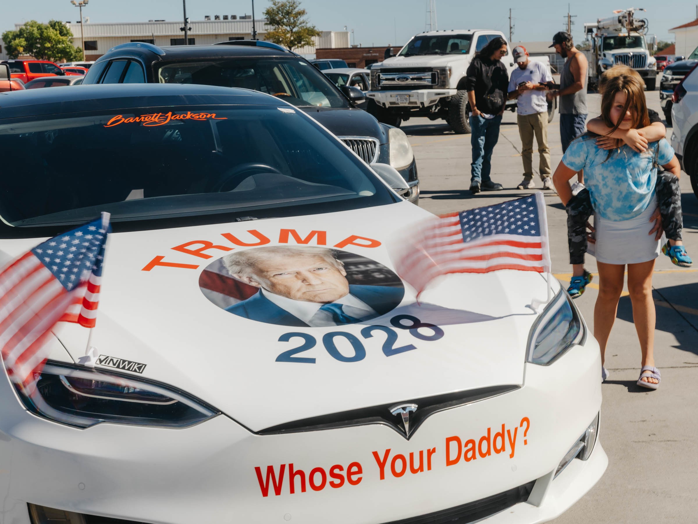 a car says Trump 2028 in a parking lot